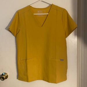 Brand new figs scrub top. 1 pocket. Never worn. Ordered 1 pocket instead of 2.